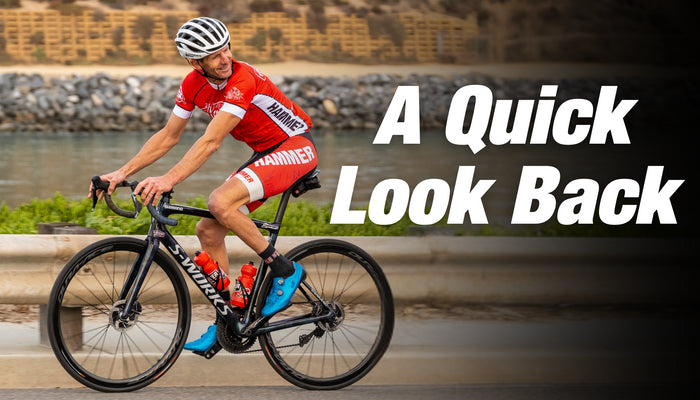 Victor Sheldon riding bike in red Hammer Kit looking back.
