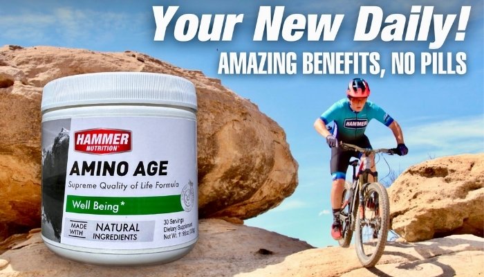 Camryn Lingle mountain biking next to big rocks with Amino Age next to him.